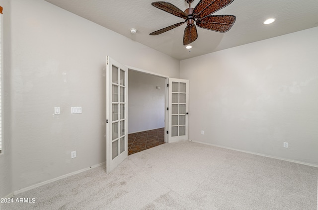 spare room featuring a ceiling fan, french doors, carpet flooring, and baseboards