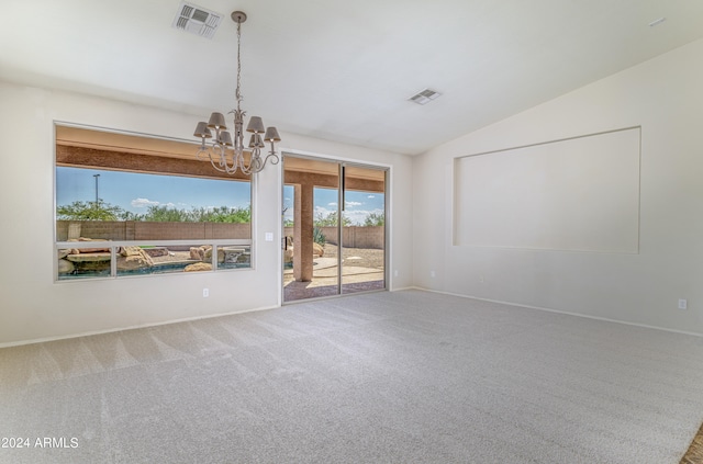 carpeted empty room featuring visible vents, vaulted ceiling, baseboards, and an inviting chandelier