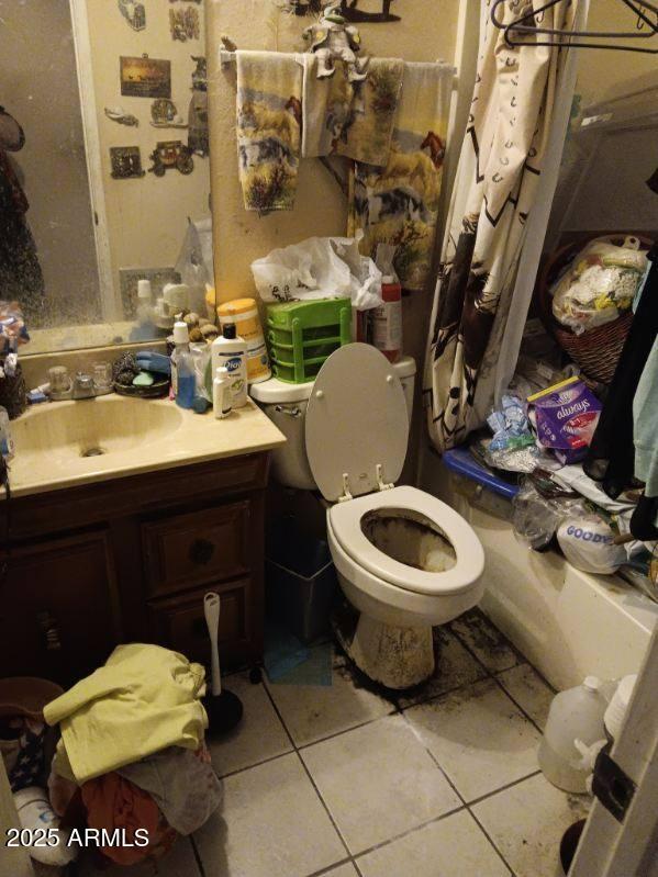 bathroom featuring vanity, toilet, and tile patterned floors