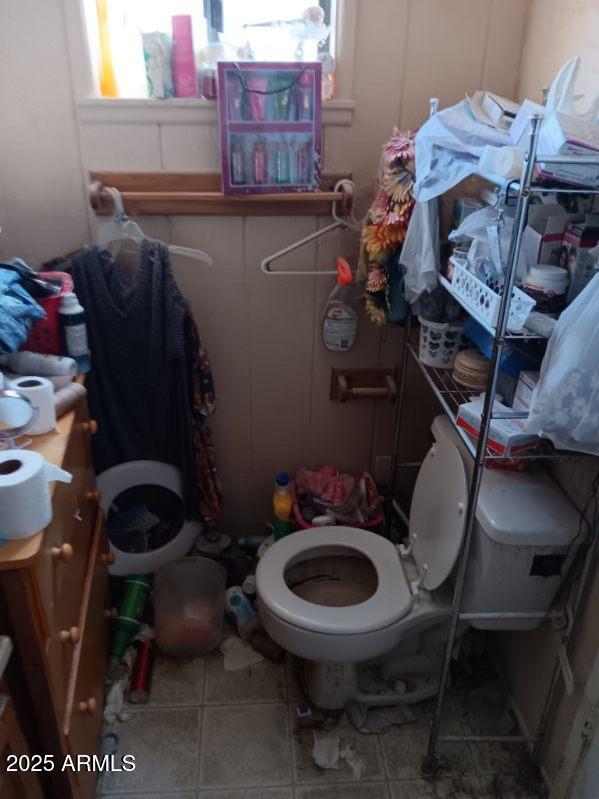 bathroom with toilet and tile patterned floors