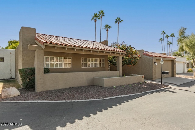 mediterranean / spanish home with a garage