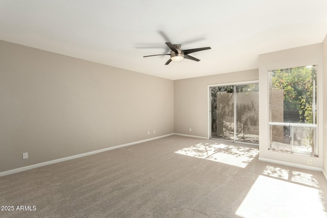 spare room with carpet floors and ceiling fan