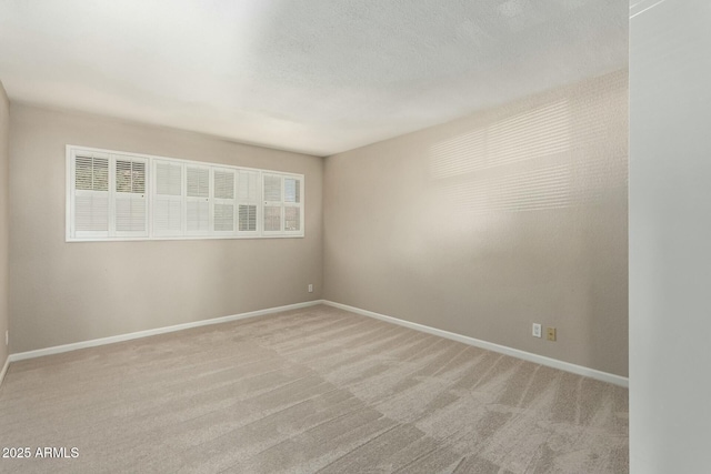 carpeted spare room with a textured ceiling