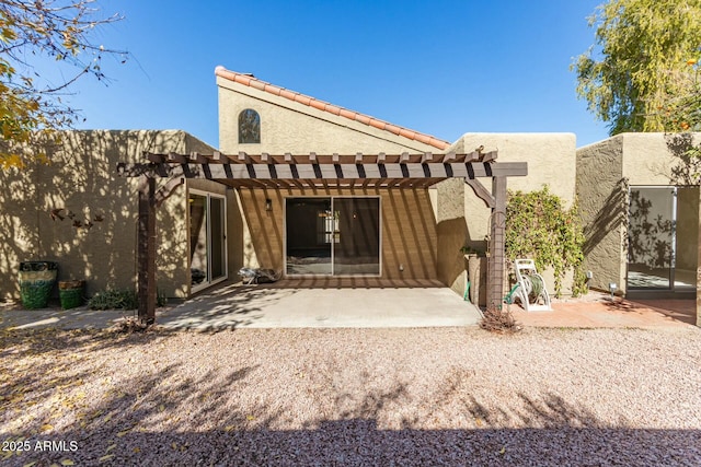 back of property featuring a pergola and a patio area