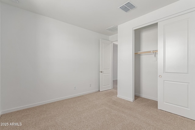 unfurnished bedroom with light carpet, baseboards, visible vents, and a closet