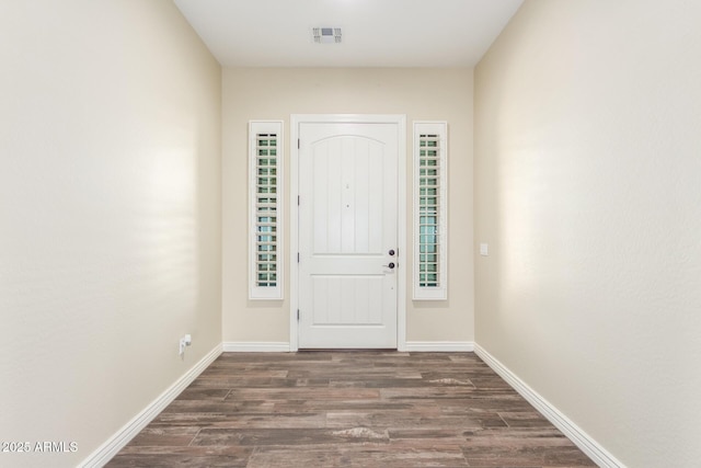 entryway featuring baseboards, visible vents, and wood finished floors