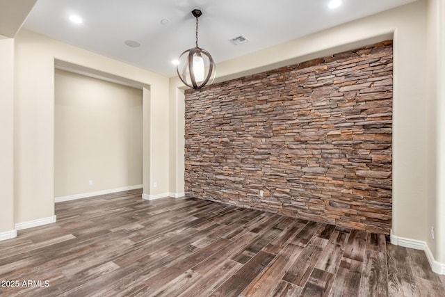 unfurnished dining area with dark wood finished floors, visible vents, and baseboards