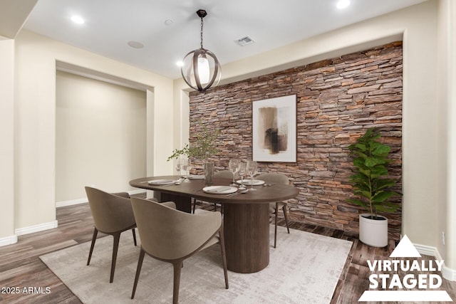 dining room featuring baseboards, visible vents, wood finished floors, and recessed lighting