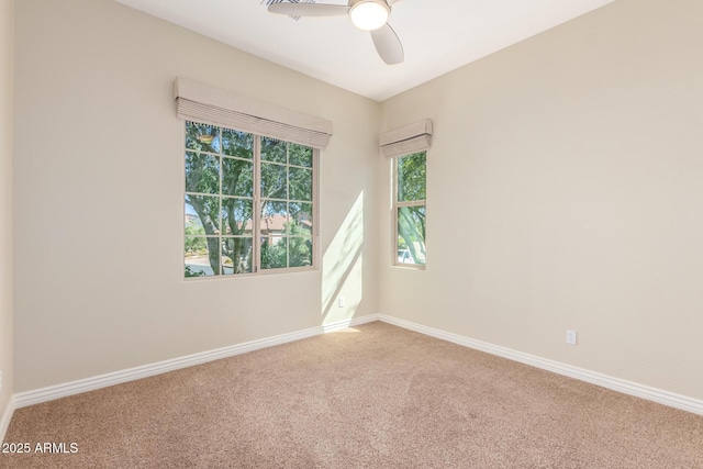 unfurnished room featuring a ceiling fan, carpet flooring, and baseboards