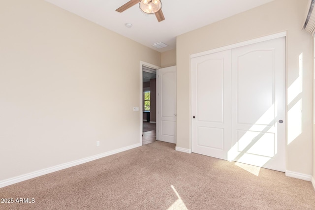 unfurnished bedroom featuring a closet, carpet, and baseboards