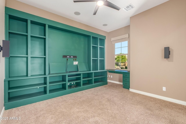 interior space with built in study area, carpet flooring, visible vents, and baseboards