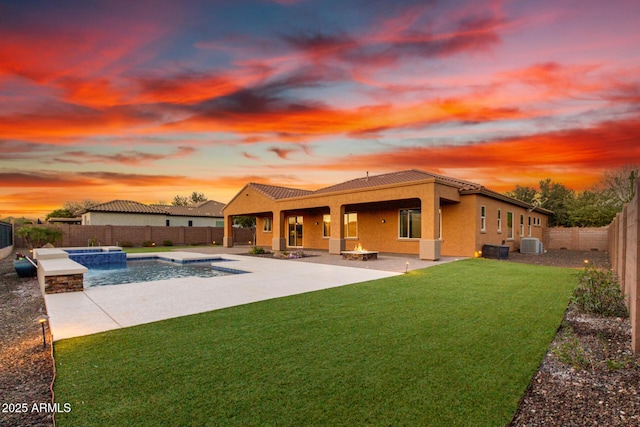 pool at dusk with a fenced in pool, a patio, a lawn, central AC, and a fenced backyard