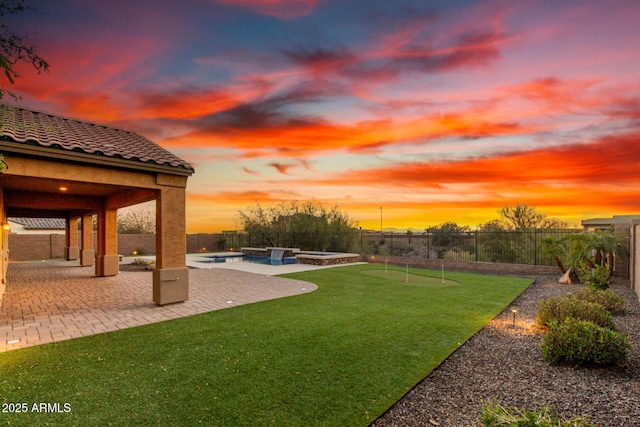 view of yard with a fenced in pool, a patio area, a fenced backyard, and an in ground hot tub