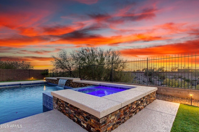 view of pool with a fenced backyard, a fenced in pool, and an in ground hot tub