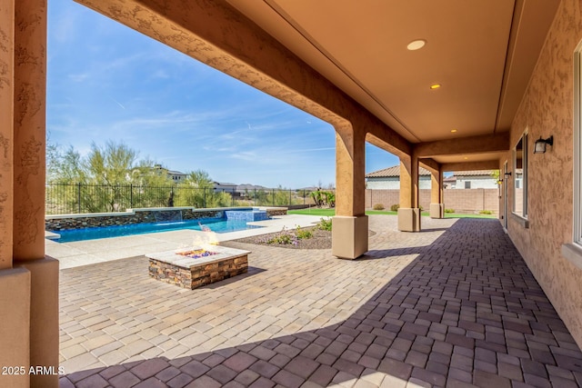 view of patio with an outdoor fire pit, a fenced backyard, and a fenced in pool