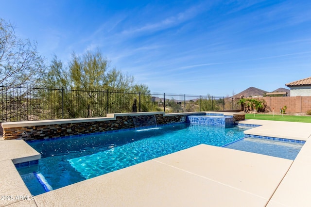 view of swimming pool with a patio area, a fenced backyard, and a pool with connected hot tub