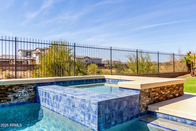 view of pool with fence, a fenced in pool, and an in ground hot tub