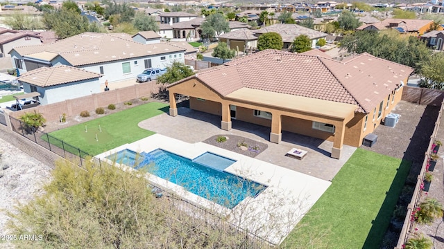 view of pool with a residential view, a fenced backyard, and a patio