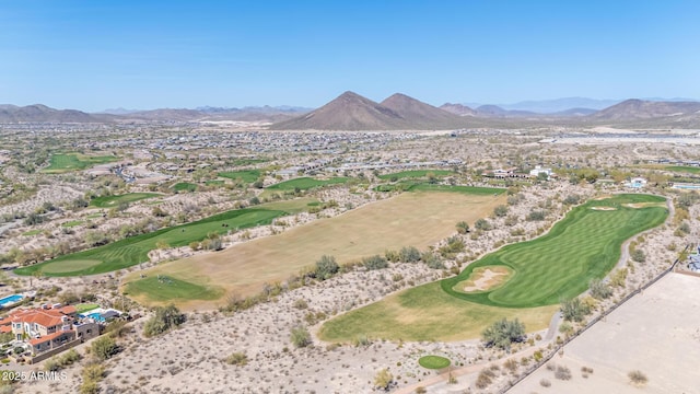 drone / aerial view with golf course view and a mountain view