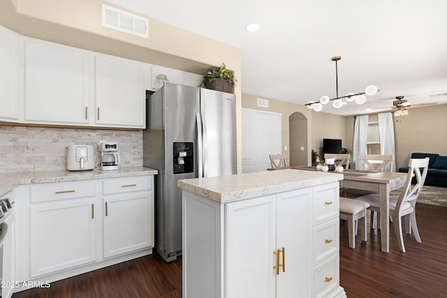 kitchen with white cabinetry, decorative light fixtures, decorative backsplash, and stainless steel fridge with ice dispenser