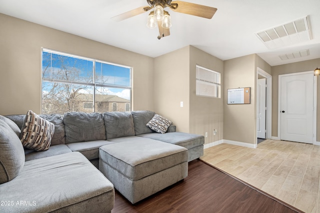 living room featuring hardwood / wood-style flooring and ceiling fan