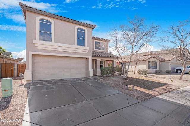 mediterranean / spanish-style home with a garage