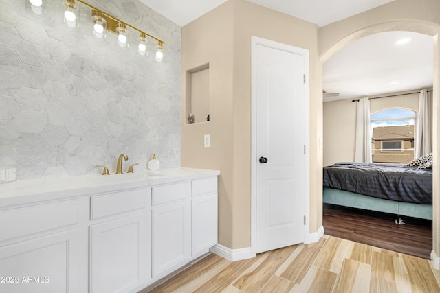 bathroom featuring vanity and tile walls