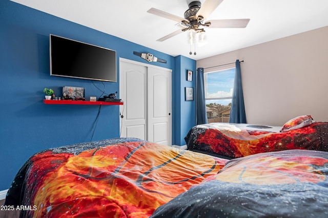 bedroom featuring ceiling fan and a closet