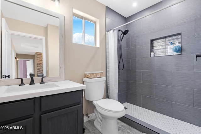 bathroom with vanity, curtained shower, and toilet