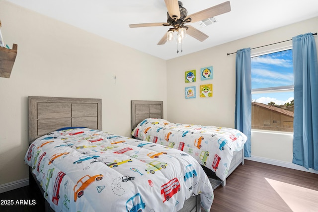 bedroom featuring ceiling fan and dark hardwood / wood-style flooring