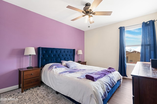 bedroom featuring light wood-type flooring and ceiling fan