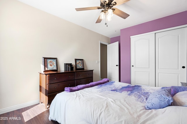 bedroom with ceiling fan, dark hardwood / wood-style floors, and a closet