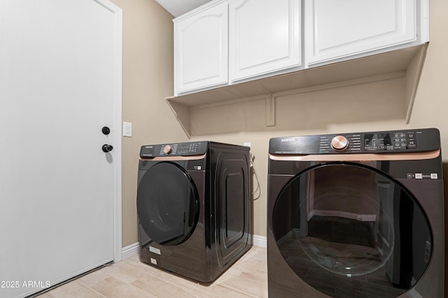 laundry area featuring cabinets and washing machine and clothes dryer