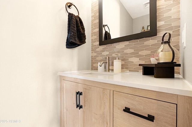 bathroom with vanity and decorative backsplash