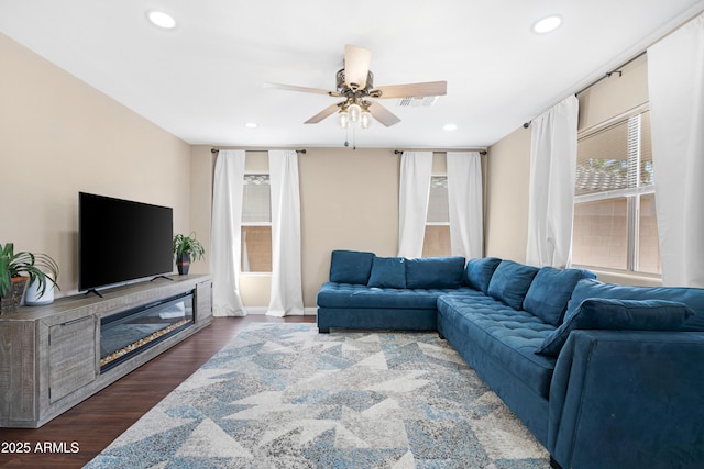 living room with dark hardwood / wood-style floors and ceiling fan