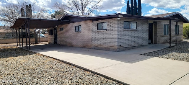 view of home's exterior featuring a carport and concrete driveway