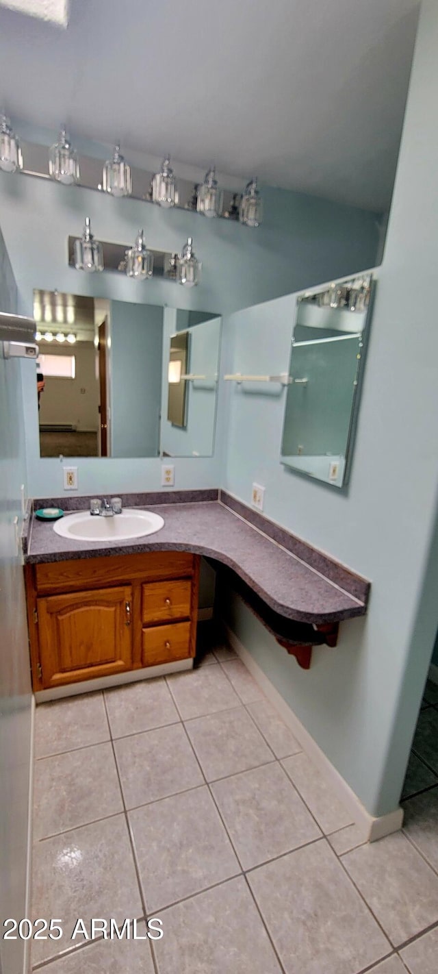 bathroom featuring baseboards, vanity, and tile patterned floors