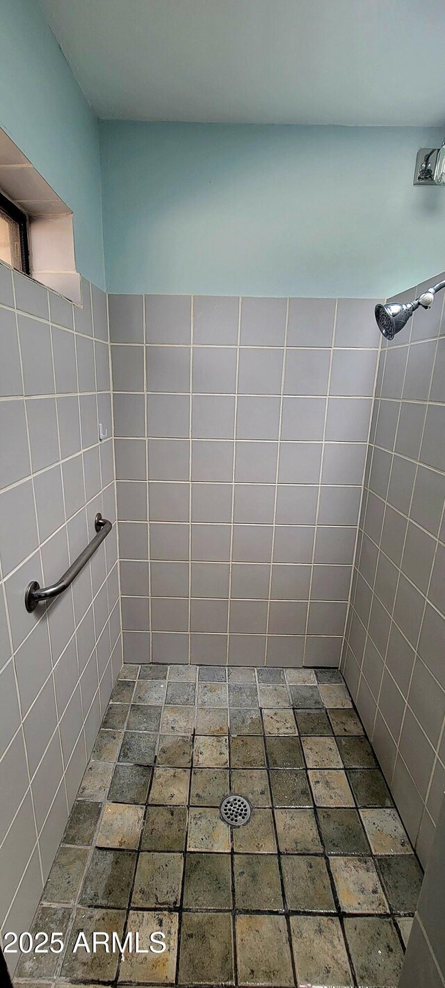 bathroom with tiled shower