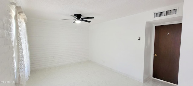 unfurnished room with a ceiling fan, baseboards, visible vents, and a textured ceiling