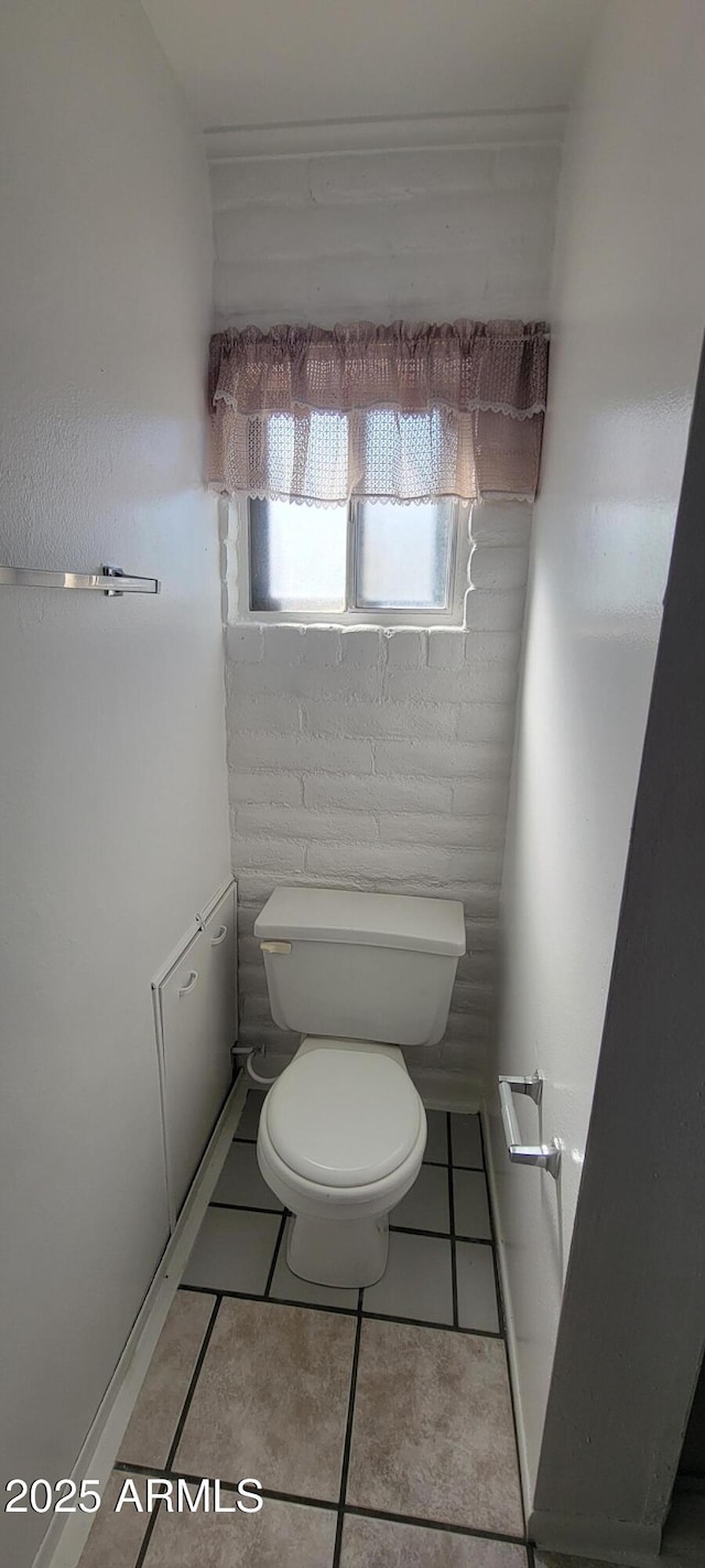 bathroom with tile patterned flooring and toilet