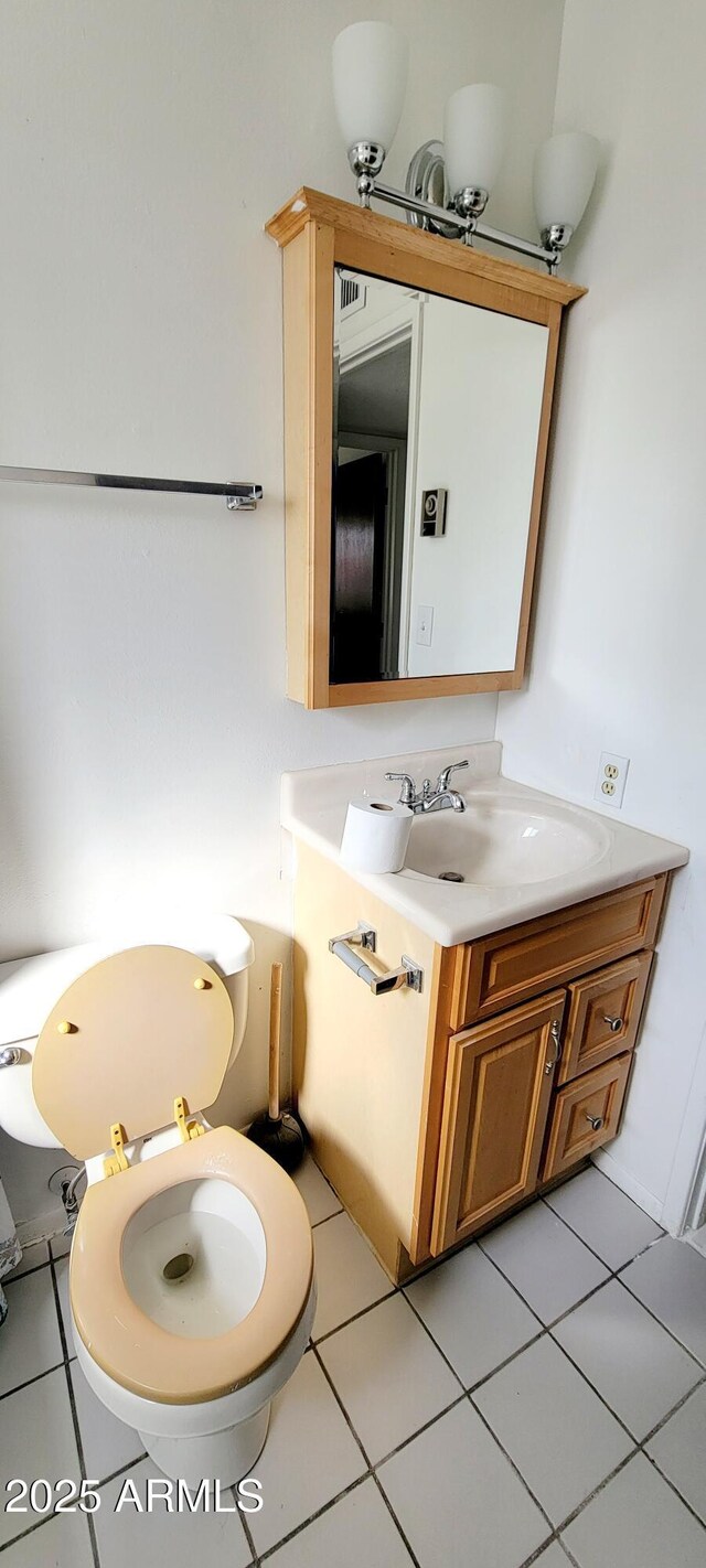 bathroom with vanity, toilet, and tile patterned floors