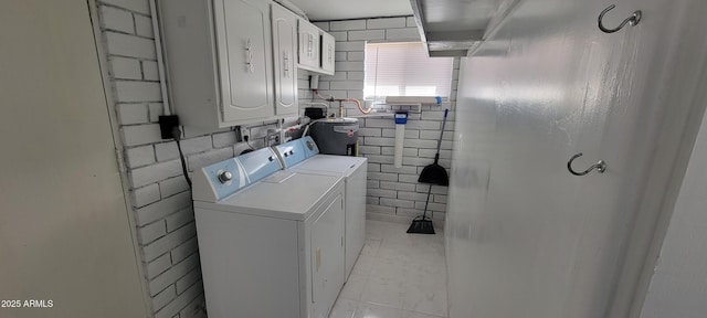 laundry room featuring cabinet space and washing machine and clothes dryer