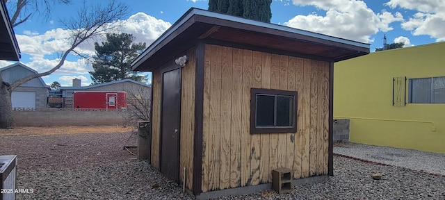 view of outbuilding with an outbuilding and fence