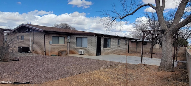 rear view of house with cooling unit and a patio area