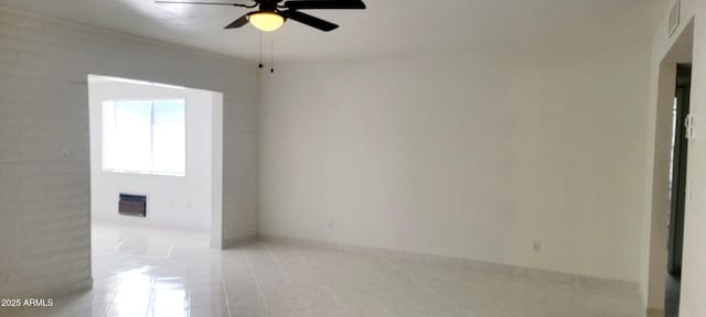 unfurnished room featuring baseboards, visible vents, and a ceiling fan