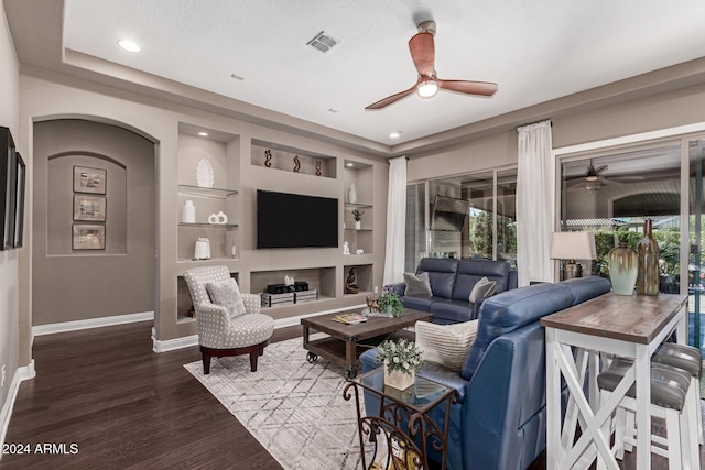 living room featuring dark hardwood / wood-style flooring and built in features