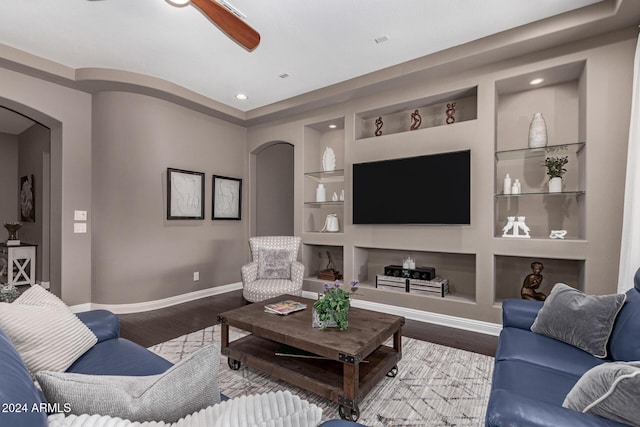 living room featuring hardwood / wood-style floors and built in features