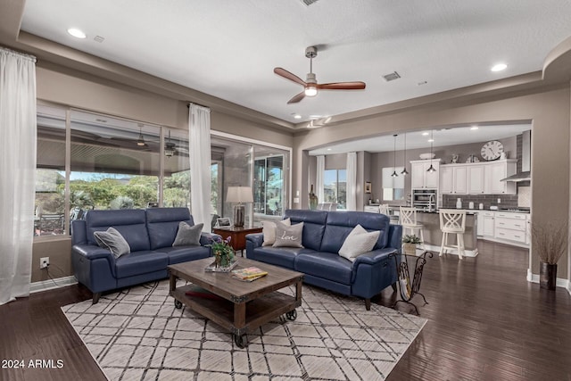 living room with hardwood / wood-style flooring and ceiling fan