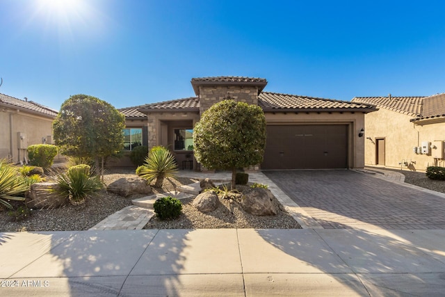 mediterranean / spanish house featuring a garage