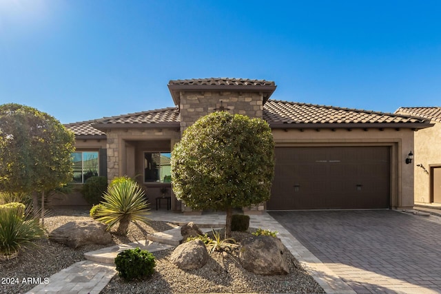 mediterranean / spanish-style home with a garage